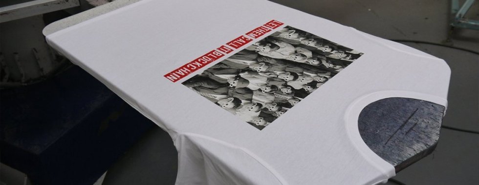 Printed shirt moving through the curing oven